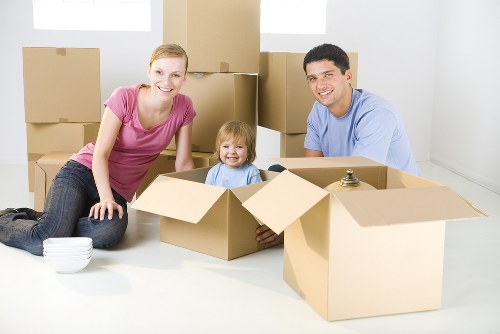 Moving van and helper loading household items for a local service