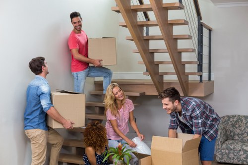 Moving boxes and furniture through a Dulwich flat staircase